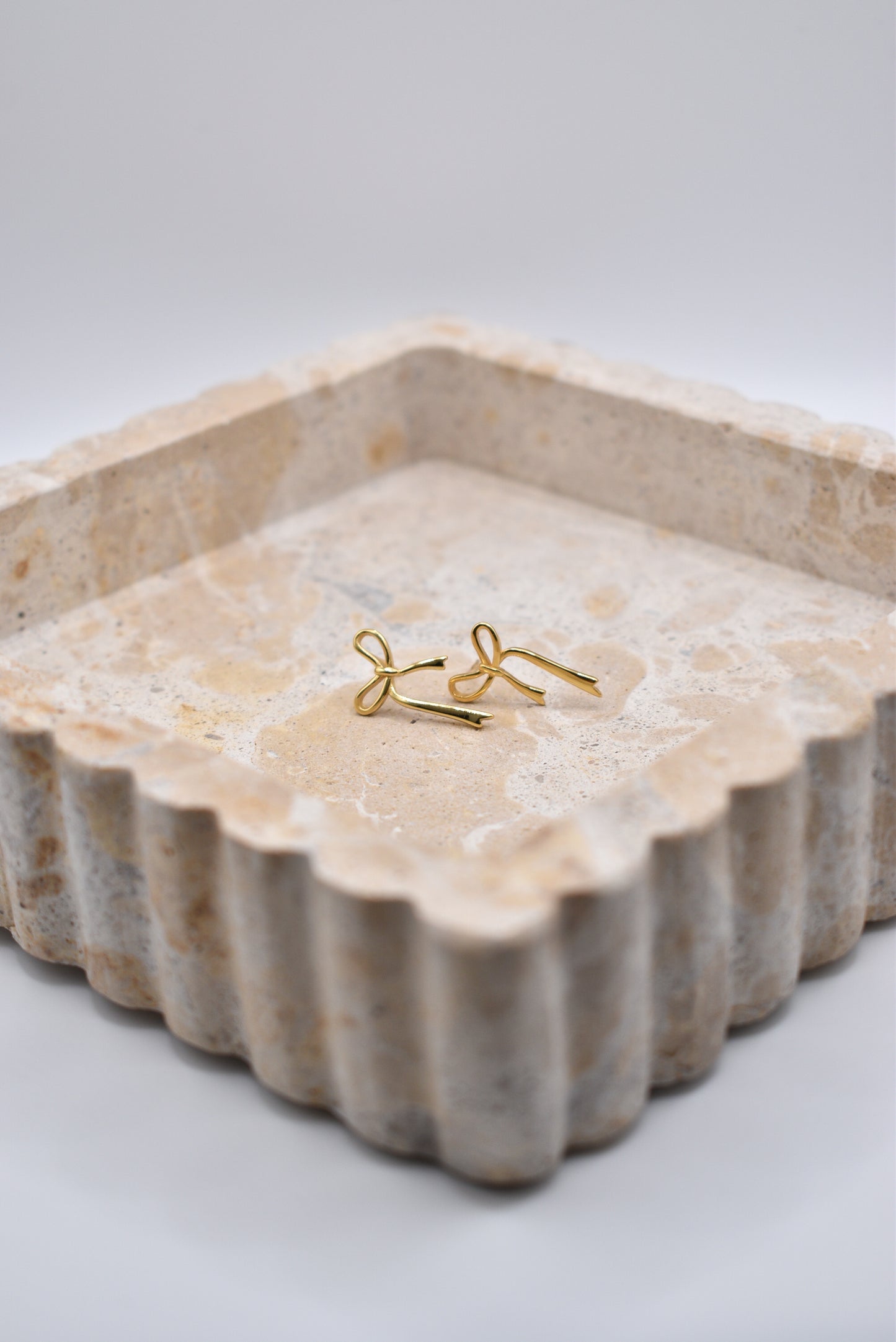 Sterling silver gold bow studs in jewelry tray