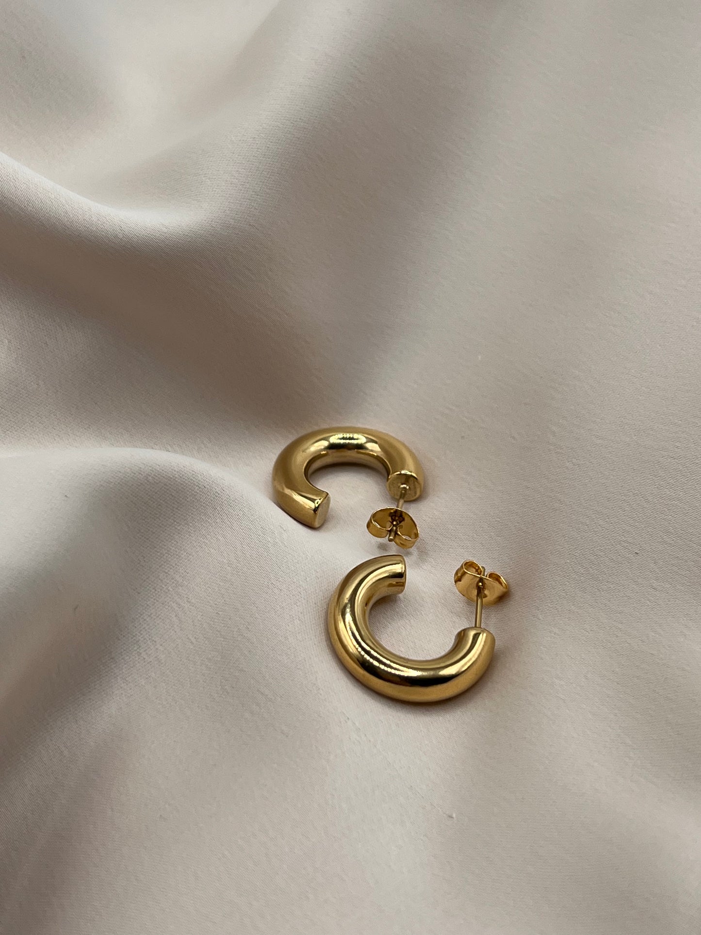 18k gold plated hoop earrings styled on satin