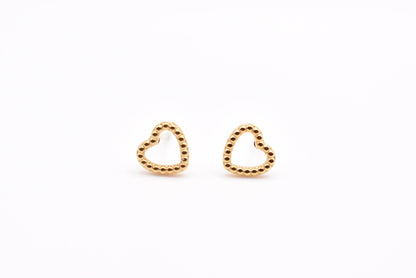 Gold minimalist heart earrings on white background

