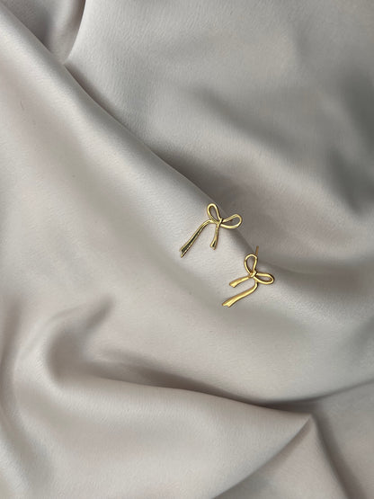 Elegant ribbon bow earrings on satin fabric